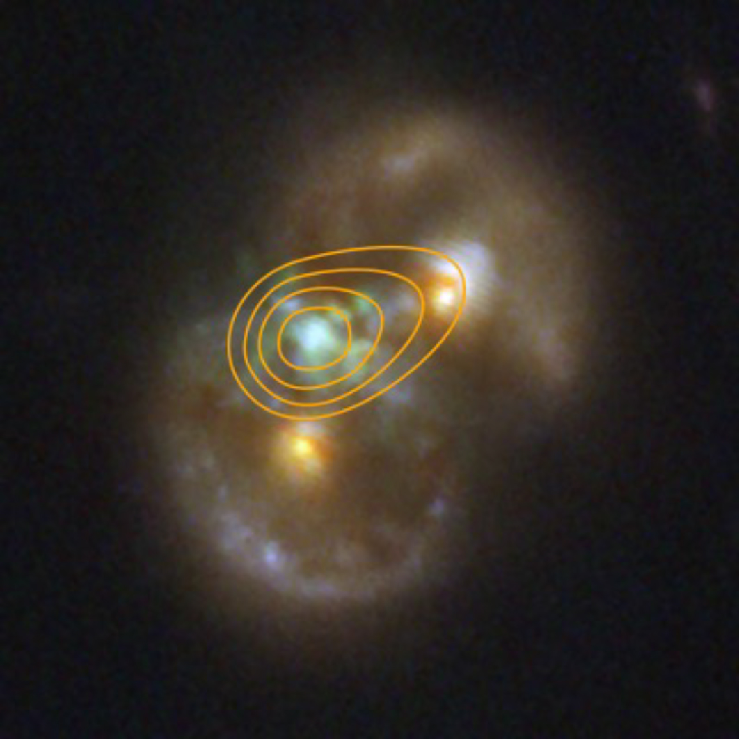 The Infinity Galaxy, the result of two colliding spiral galaxies, is composed of two rings of stars (seen as ovals at upper right and lower left). The two nuclei of the spiral galaxies are seen represented in yellow within the rings. Glowing hydrogen that has been stripped of its electrons between the two galaxies appears green. Within that region blue gas suggest the presence of a third supermassive black hole. Yellow countoru line trace radio emission agreeing with the presence of an active black hole. The Infinity Galaxy, the result of two colliding spiral galaxies, is composed of two rings of stars (seen as ovals at upper right and lower left). The two nuclei of the spiral galaxies are seen represented in yellow within the rings. Glowing hydrogen that has been stripped of its electrons between the two galaxies appears green. Within that region blue gas suggest the presence of a third supermassive black hole. Yellow countoru line trace radio emission agreeing with the presence of an active black hole.