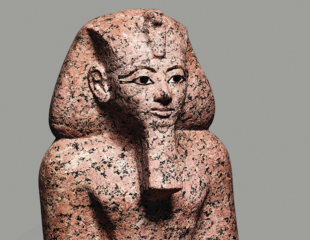 A small kneeling statue of Hatshepsut with its face fully intact. A small kneeling statue of Hatshepsut with its face fully intact.