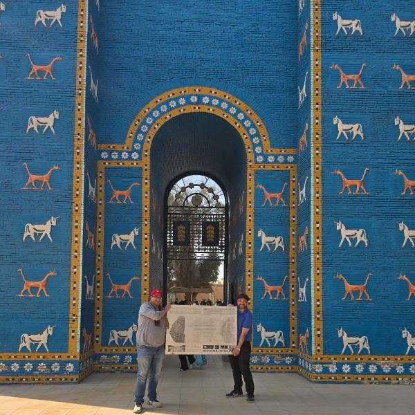 Enrique Jiménez and Anmar Fadhil stand in front of the replica of the Ishtar Gate, once considered so world leading it had a place in the hymn