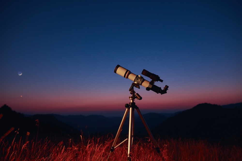 Telescope standing in a field looking up at the sky. Telescope standing in a field looking up at the sky.
