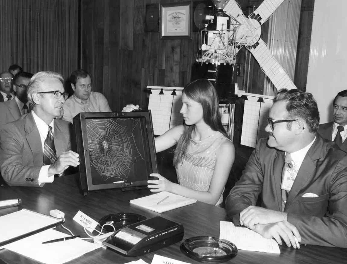High school student Judith Miles discusses her proposed Skylab experiment with Keith Demorest and Henry Floyd, both of Marshall Space Flight Center, in 1972. High school student Judith Miles discusses her proposed Skylab experiment with Keith Demorest and Henry Floyd, both of Marshall Space Flight Center, in 1972.