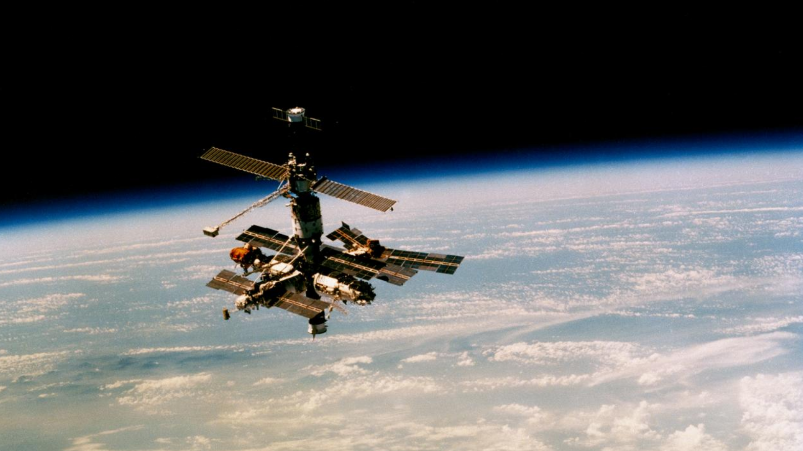 The Soviet Mir Space Station orbiting Earth in space. The Soviet Mir Space Station orbiting Earth in space.