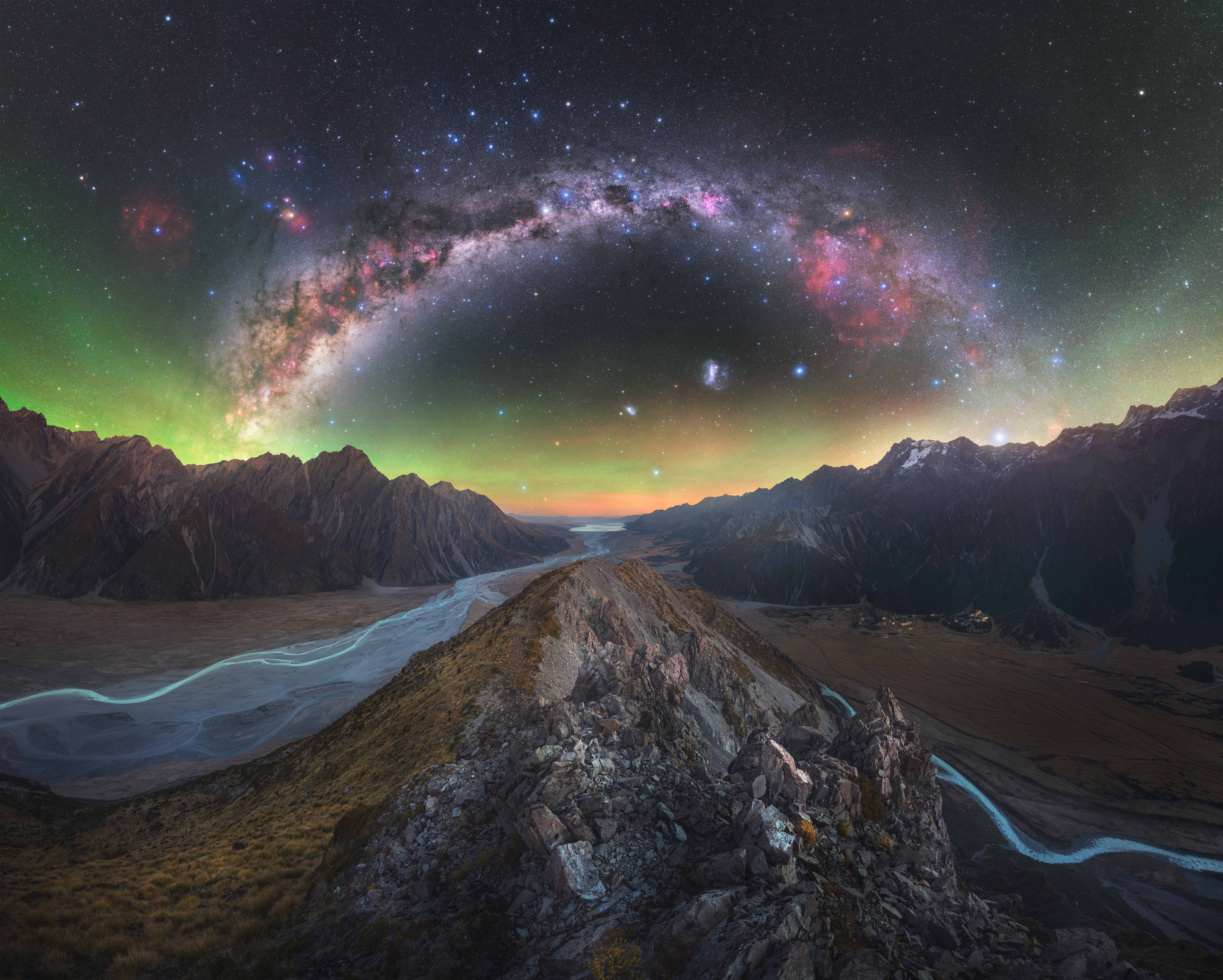The photograph captures the twin glacial rivers on either side of a ridge, with the Milky Way stretching across the sky, as well as the famous Southern Cross and the magellanic clouds in the sky. 