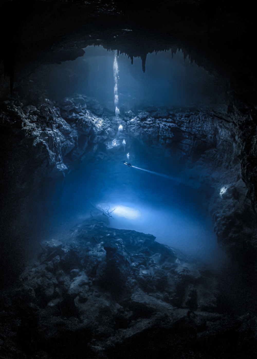 diver goes into a cenote in cancun