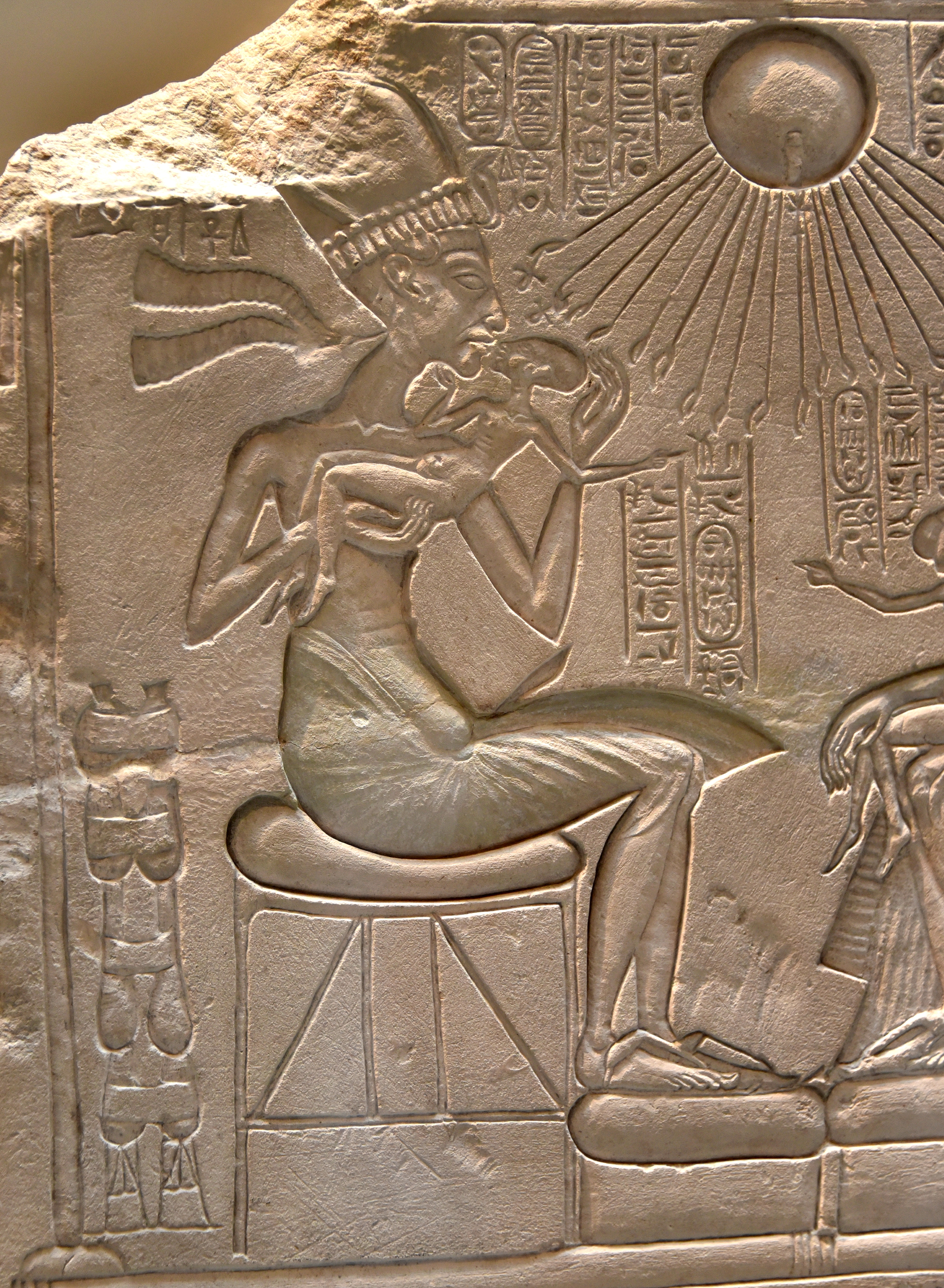 Akhenaten and one of his girls, detail of an altarpiece of a shrine. The God Aten with his sun rays and his cartouches as well as Nefertiti's cartouches appear. New Kingdom, 18th Dynasty, c. 1345 BCE. From Amarna, Egypt. Neues Museum, Berlin, Germany. ÄM14145. Akhenaten and one of his girls, detail of an altarpiece of a shrine. The God Aten with his sun rays and his cartouches as well as Nefertiti's cartouches appear. New Kingdom, 18th Dynasty, c. 1345 BCE. From Amarna, Egypt. Neues Museum, Berlin, Germany. ÄM14145.