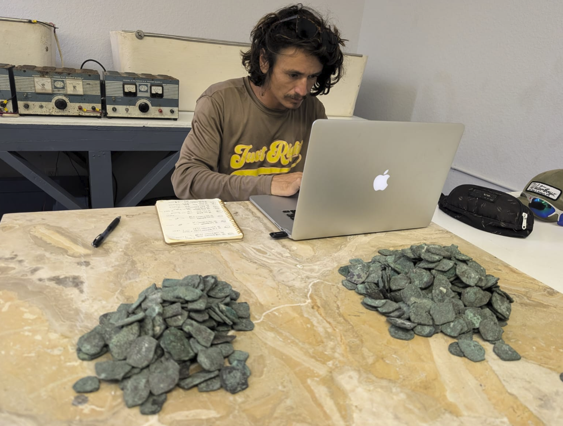 Captain Levin Shavers documents some of the recently discovered silver coins.