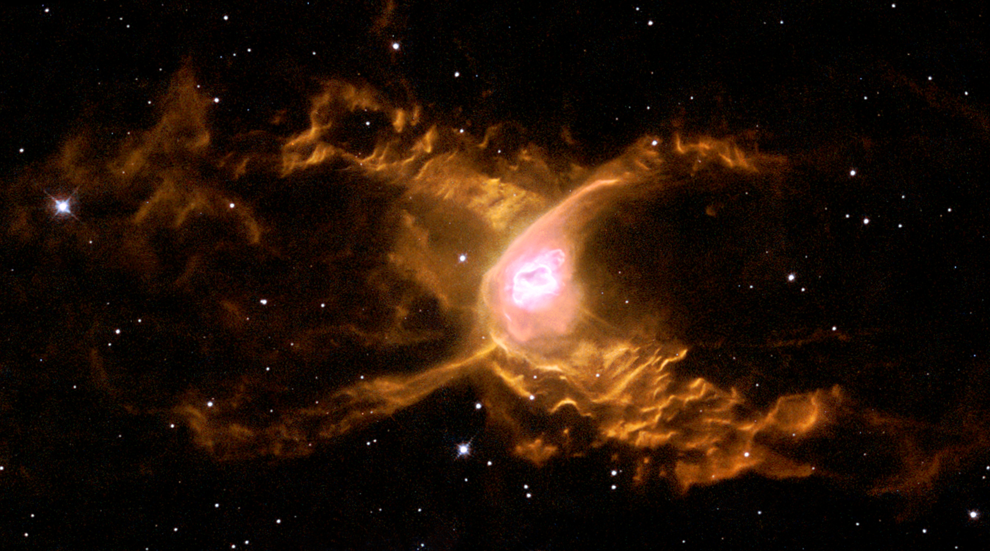 the nebula looks like two interlocking semicircles, the legs of the spider, with a bright messy central region. the nebula looks like two interlocking semicircles, the legs of the spider, with a bright messy central region.