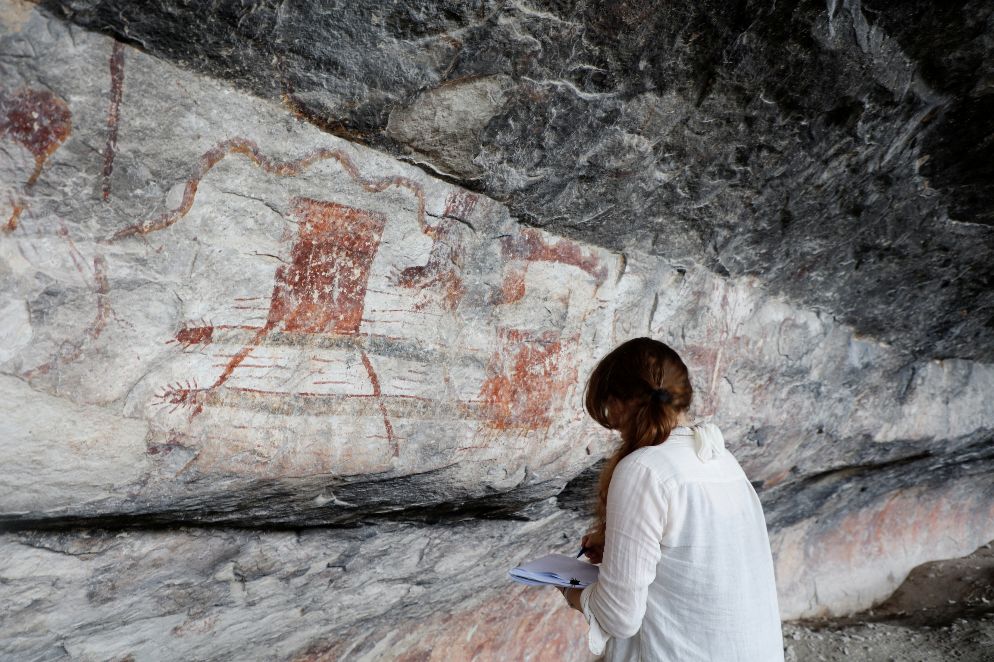 Archaeologist drawing a rock art panel at Seminole Canyon State Park & Historic Site. Archaeologist drawing a rock art panel at Seminole Canyon State Park & Historic Site.