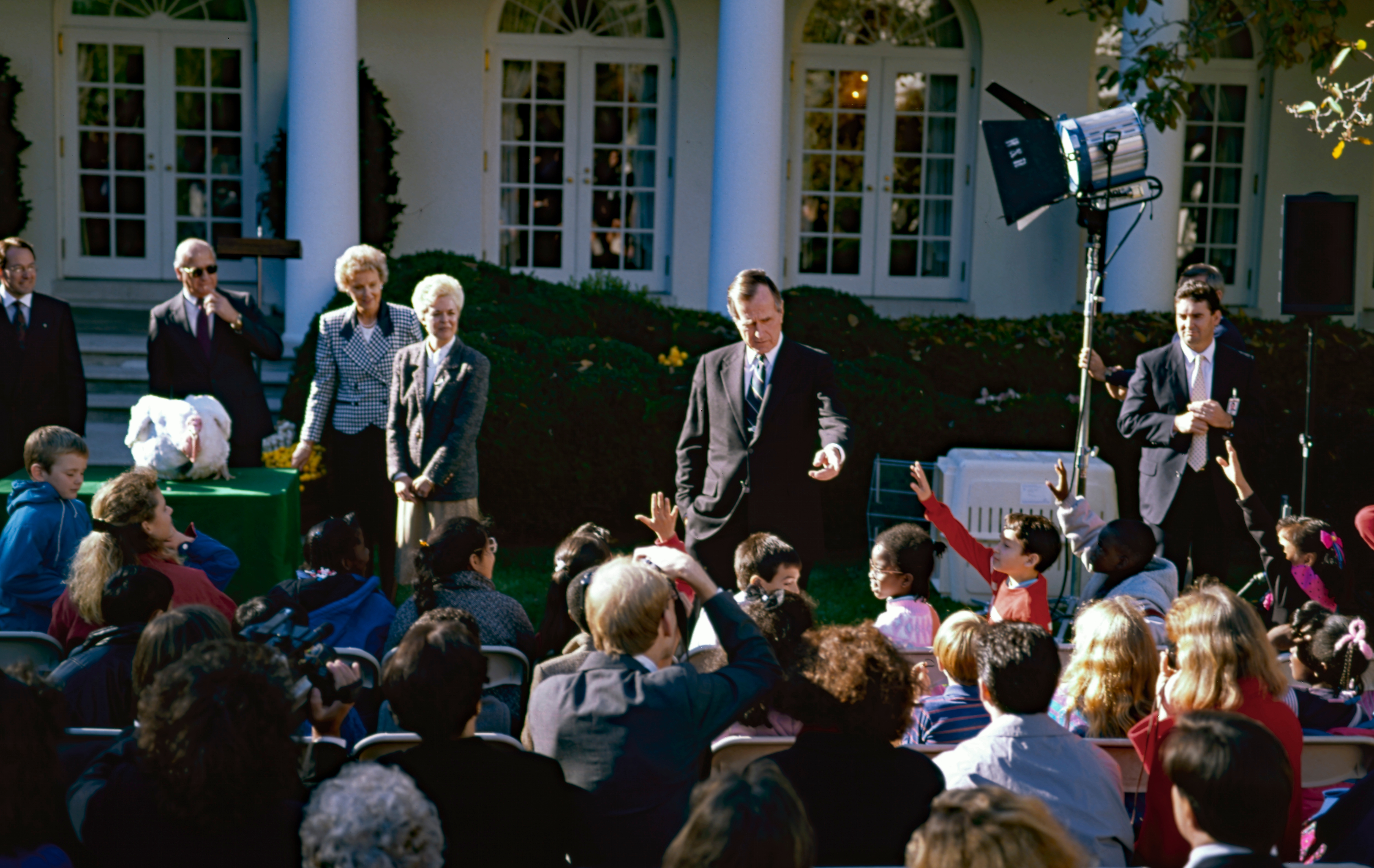 Washington DC, USA, November 14, 1990. President George H.W. Bush answers a question from one of the children attending the annual Thanksgiving turkey pardoning in the Rose Garden of the White House Washington DC, USA, November 14, 1990. President George H.W. Bush answers a question from one of the children attending the annual Thanksgiving turkey pardoning in the Rose Garden of the White House